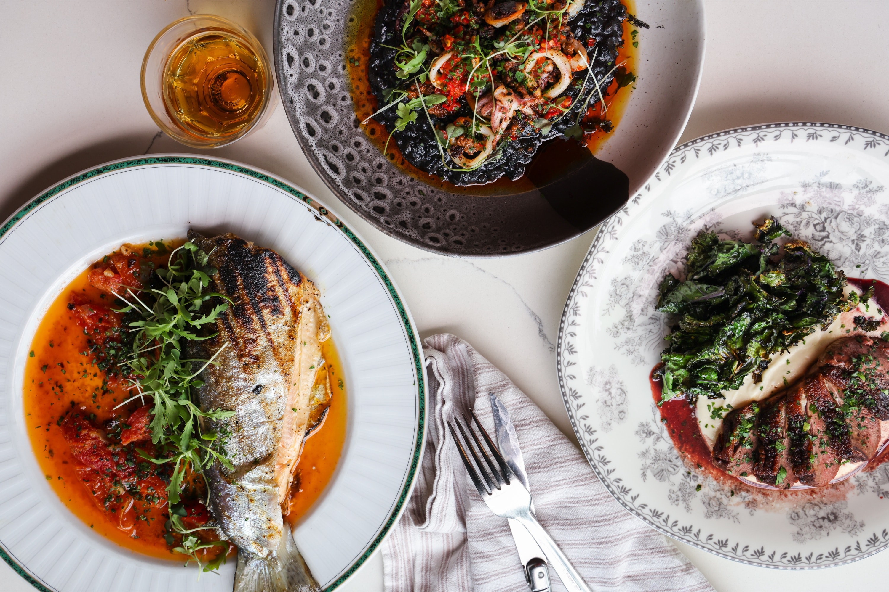 Dinner at Stumble Out: whole grilled fish, squid-ink rice and duck across the table